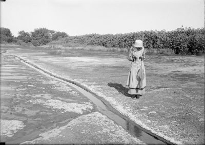 black and white photograph of saline pool shoreline and one woman
