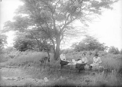 black and white photograph of landscape and three seated women
