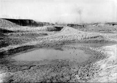 black and white photograph of mud pit and water