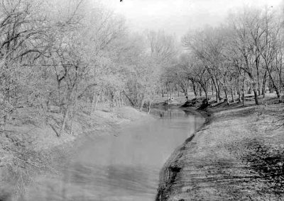 black and white photograph of creek and shore