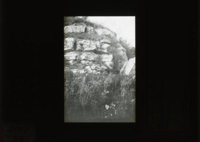 Black and white photograph of limestone along hill