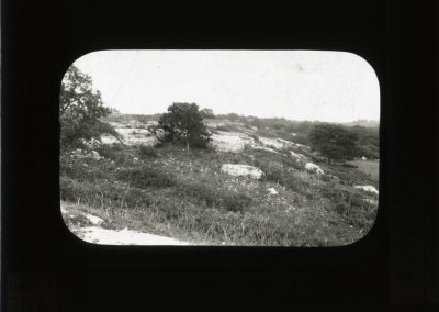 Black and white photograph of limestone blocks along hillside