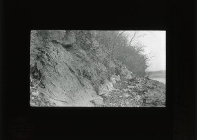 Black and white photograh of rock ledge along a hillside