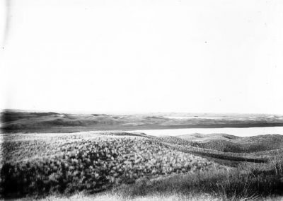 black and white photo of three lakes close together amid grassy slopes